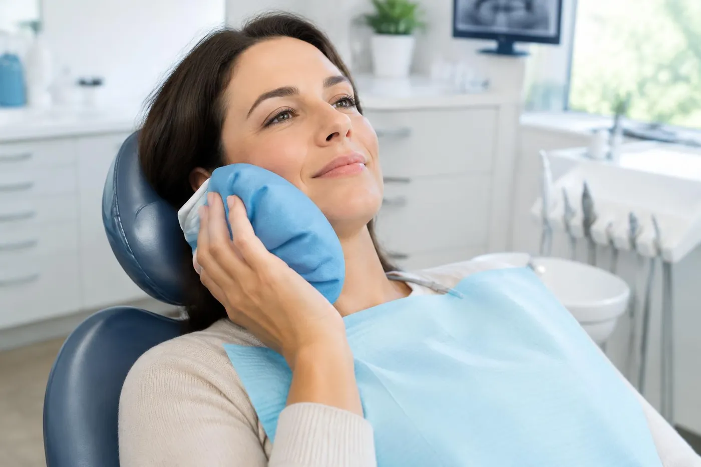 Patient resting with a cold compress after dental implant surgery in Welland