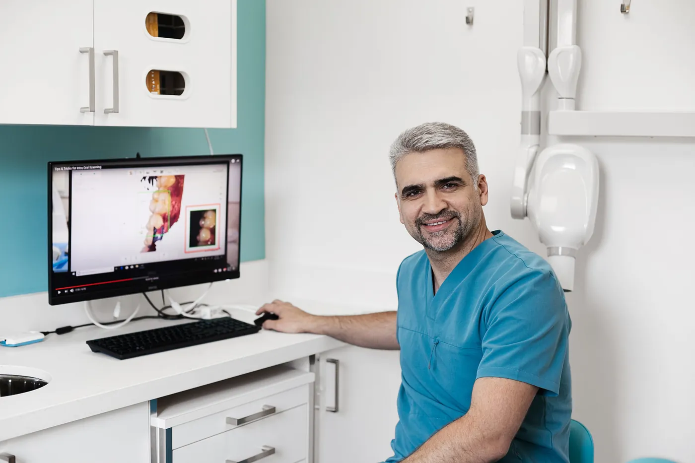 Dr. Yasser at the dental workstation in the treatment room